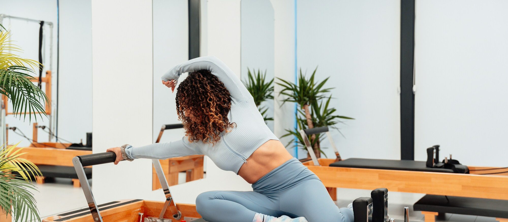 A Beam Pilates teacher guiding a reformer session